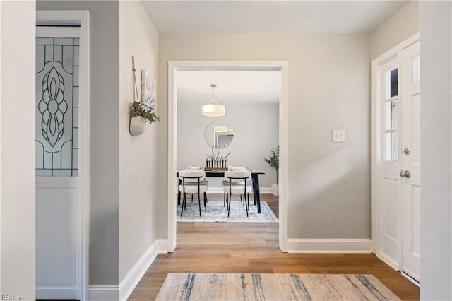 entryway with wood finished floors and baseboards