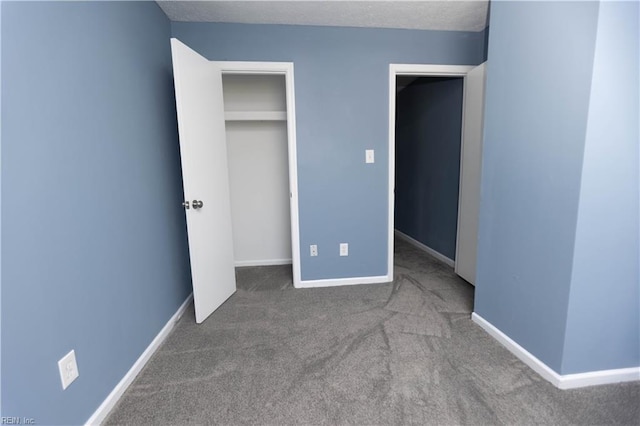 unfurnished bedroom with carpet flooring and baseboards