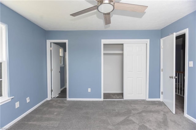 unfurnished bedroom featuring baseboards, a closet, ceiling fan, and carpet floors