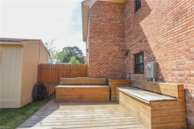 wooden terrace featuring fence