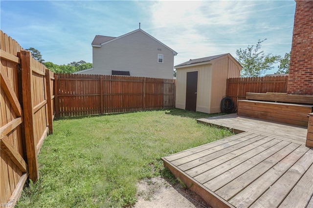 view of yard featuring a fenced backyard, a wooden deck, and a shed