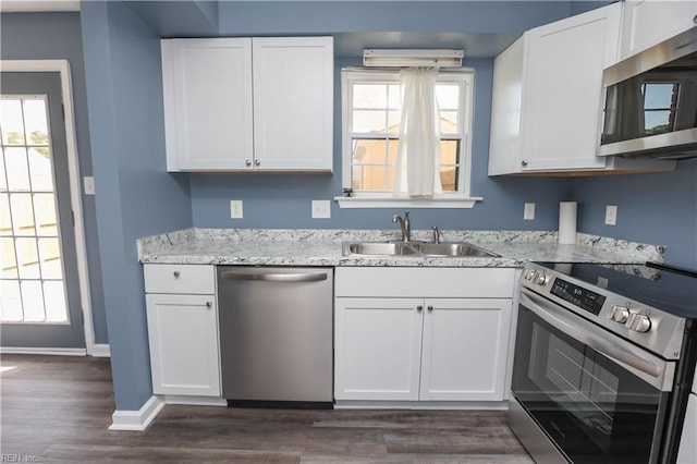 kitchen featuring a sink, dark wood-style flooring, stainless steel appliances, and white cabinets