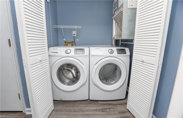 laundry area featuring laundry area, independent washer and dryer, and wood finished floors
