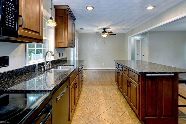 kitchen featuring a ceiling fan, recessed lighting, baseboards, a sink, and black appliances