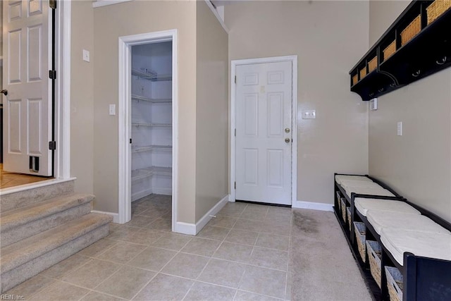 interior space featuring baseboards and light tile patterned flooring