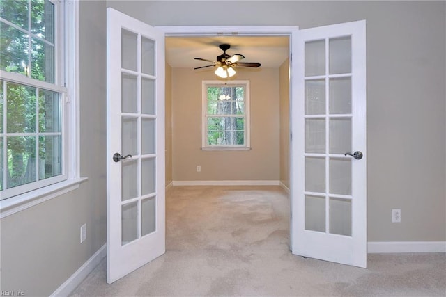 spare room with baseboards, french doors, and carpet floors