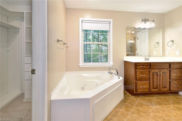 bathroom featuring vanity, a whirlpool tub, and tile patterned flooring