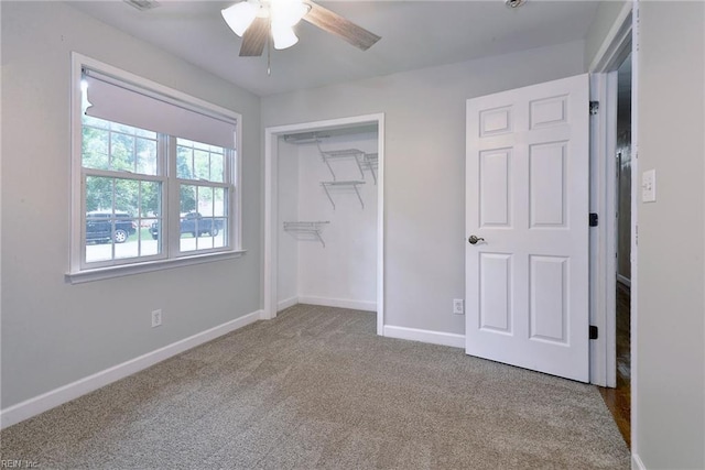 unfurnished bedroom featuring baseboards, a closet, ceiling fan, and carpet
