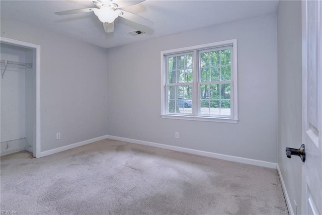 unfurnished bedroom with carpet floors, baseboards, and visible vents