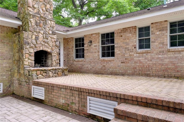 view of patio with an outdoor stone fireplace