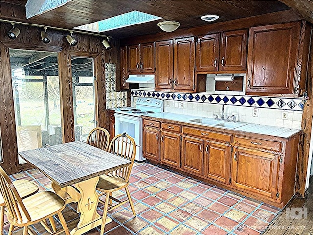 3810 Seaford Rd, Seaford, VA 23696 - kitchen featuring white electric range, tile countertops, tasteful backsplash, and a sink
