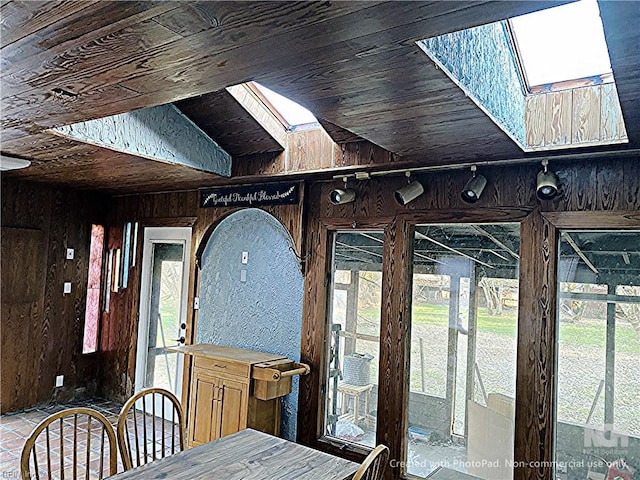 3810 Seaford Rd, Seaford, VA 23696 - dining area featuring wooden walls, wood ceiling, lofted ceiling with skylight, and plenty of natural light
