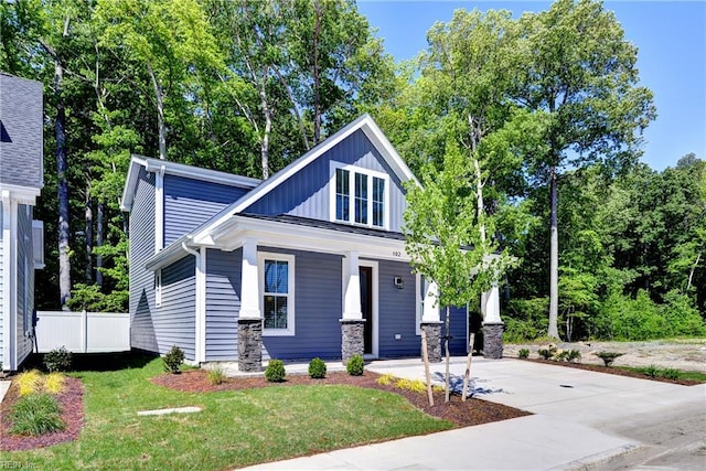 102 Blue Crab Pt, Poquoson, VA 23662 - view of front of home with covered porch, concrete driveway, fence, and a front yard