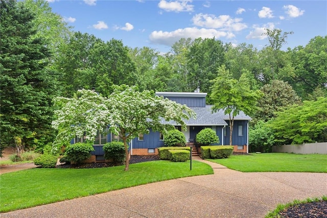 view of front of home with roof with shingles and board and batten siding