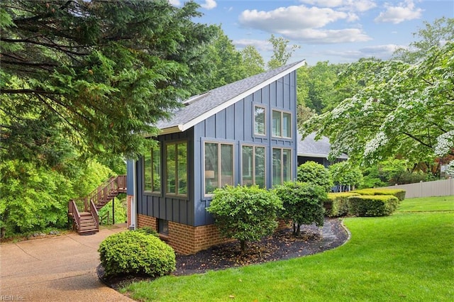 view of outbuilding featuring stairs and a sunroom
