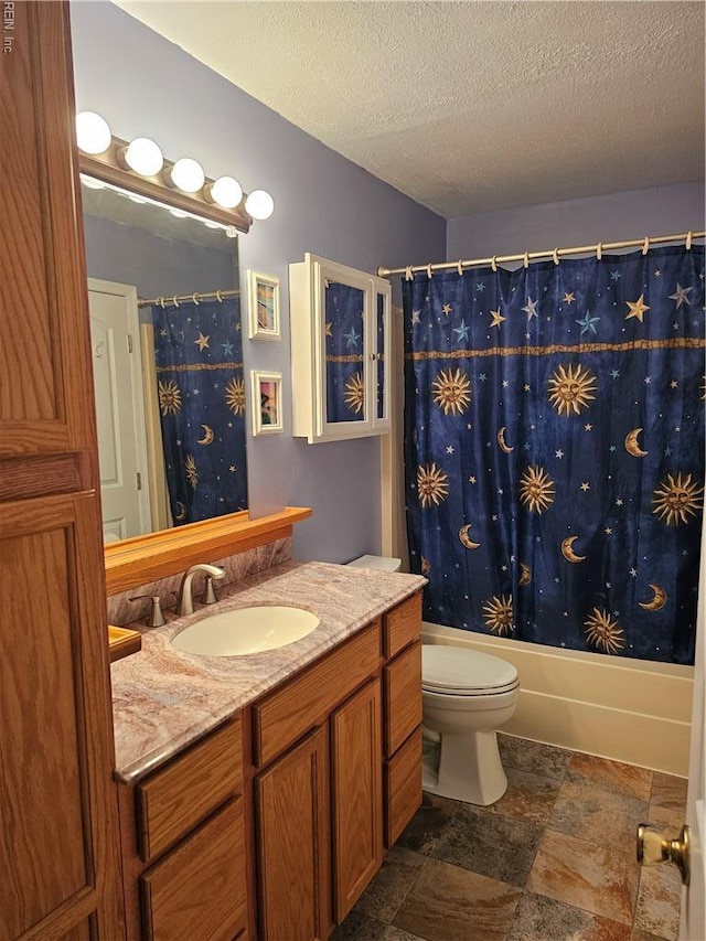 full bath with toilet, shower / bath combo, stone finish floor, a textured ceiling, and vanity