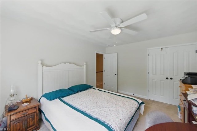 bedroom featuring a ceiling fan, a closet, and carpet floors