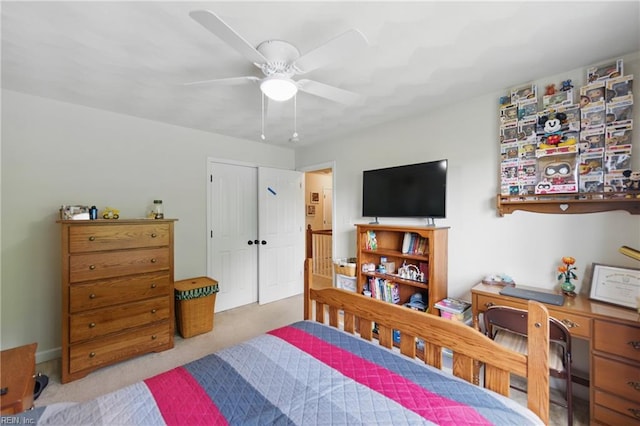 bedroom with a ceiling fan and carpet