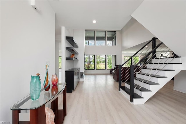 stairway featuring recessed lighting and wood finished floors