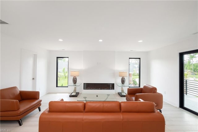 living area featuring light wood-style floors, visible vents, and recessed lighting