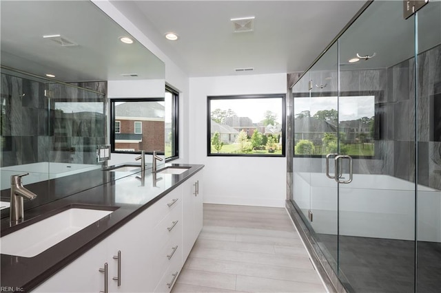 full bath with recessed lighting, a stall shower, and a sink