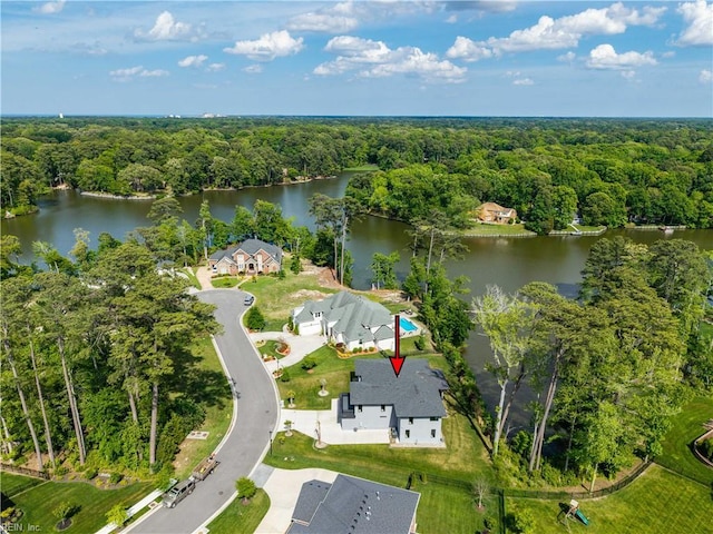 birds eye view of property featuring a water view and a forest view