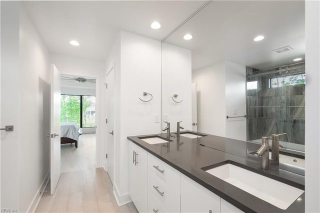 bathroom with recessed lighting, plenty of natural light, and a sink