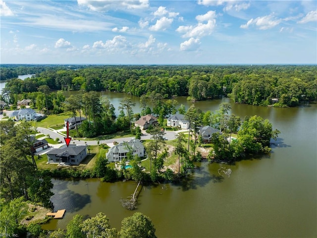 drone / aerial view with a forest view and a water view