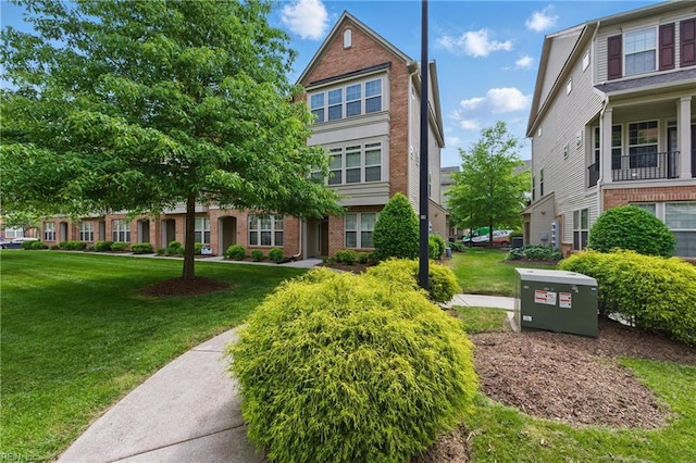 view of front of house featuring a front yard and brick siding