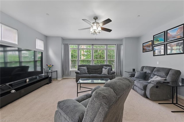 living room featuring carpet flooring, a ceiling fan, and baseboards