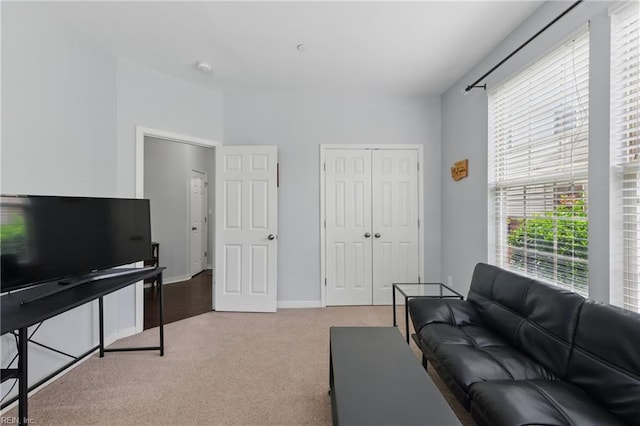 carpeted living room with baseboards