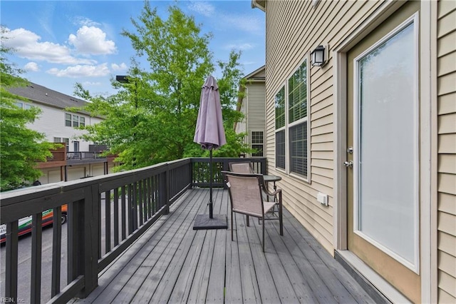 wooden deck featuring outdoor dining area