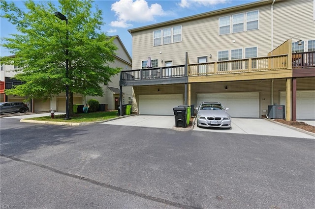 rear view of house with an attached garage and driveway