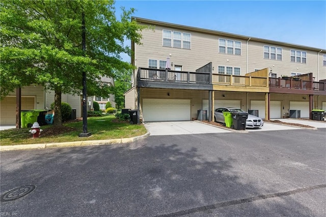 back of property with a garage and driveway
