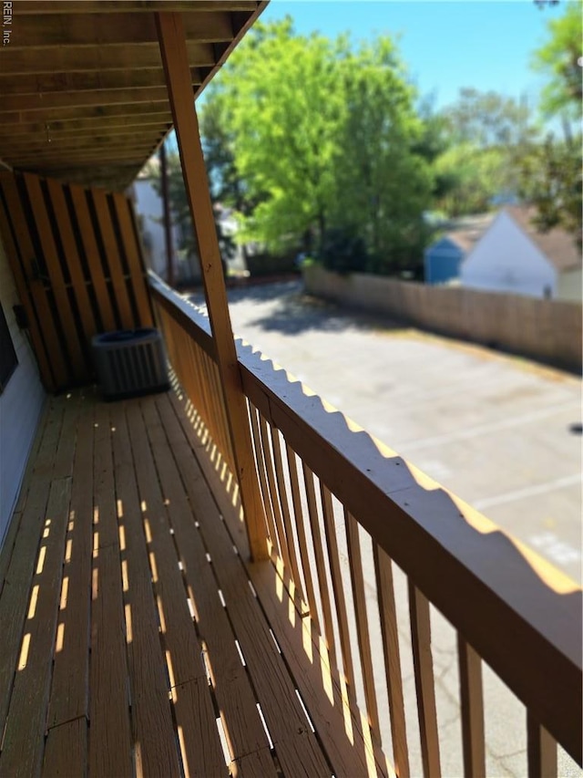 wooden deck featuring cooling unit