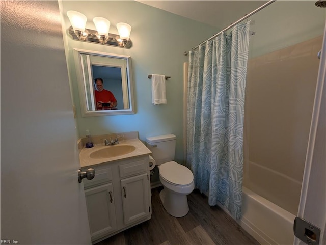 full bathroom featuring toilet, wood finished floors, vanity, and shower / bathtub combination with curtain