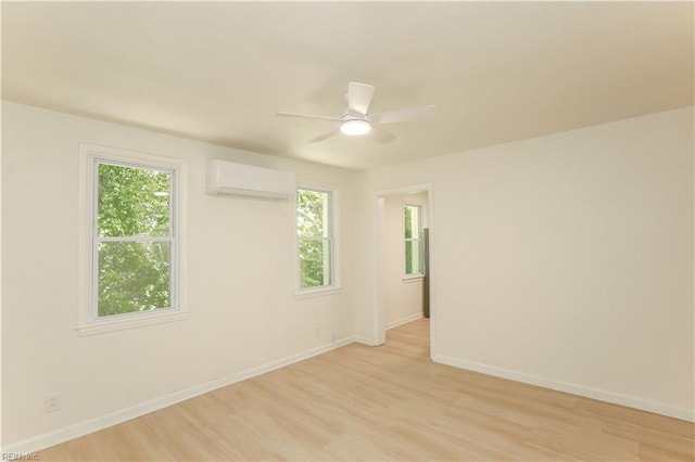 48 Pollux Cir W, Portsmouth, VA 23701 - unfurnished room featuring a wall mounted air conditioner, plenty of natural light, and light wood-style floors