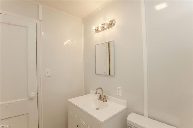 48 Pollux Cir W, Portsmouth, VA 23701 - half bath featuring vanity, toilet, and crown molding