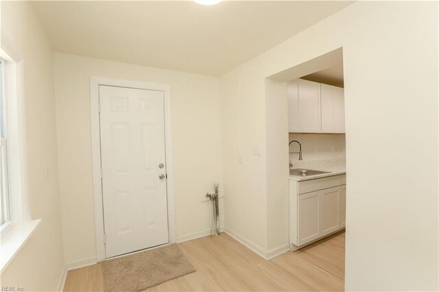 48 Pollux Cir W, Portsmouth, VA 23701 - washroom with a sink, baseboards, and light wood-type flooring