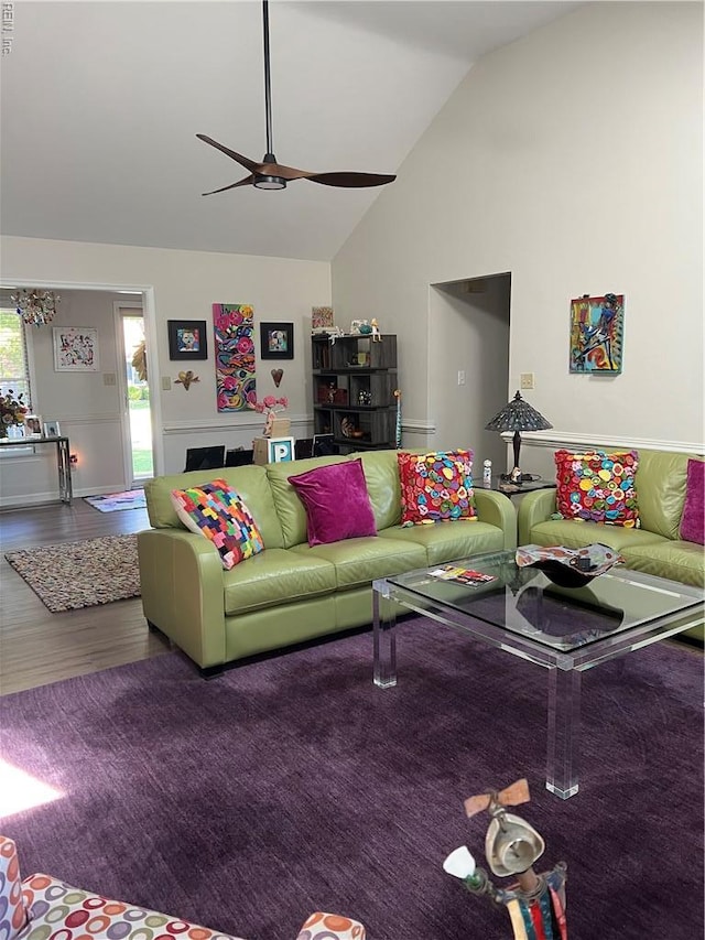 living room featuring a ceiling fan, high vaulted ceiling, and wood finished floors