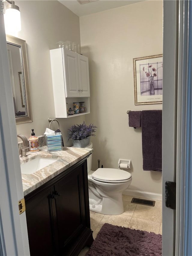 bathroom with toilet, visible vents, baseboards, tile patterned flooring, and vanity