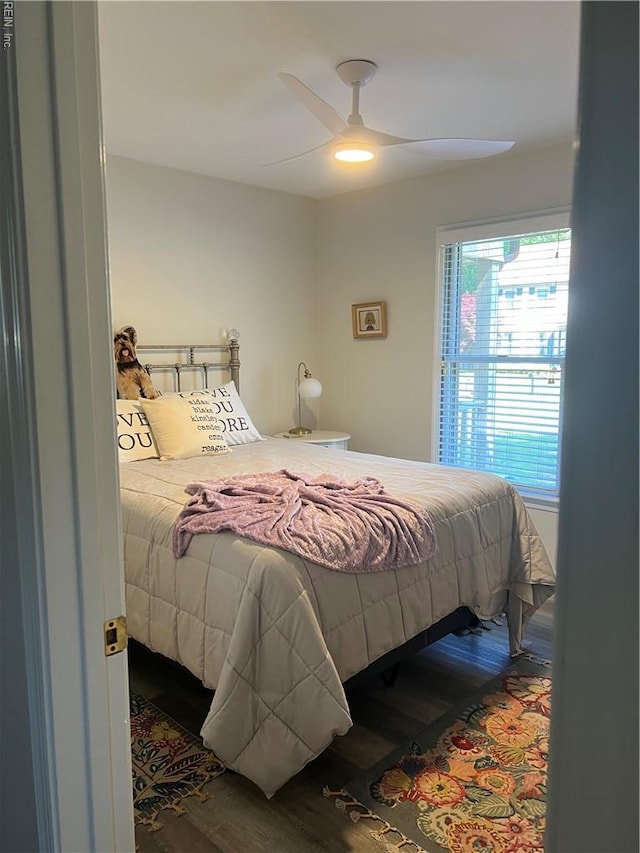bedroom with a ceiling fan and wood finished floors
