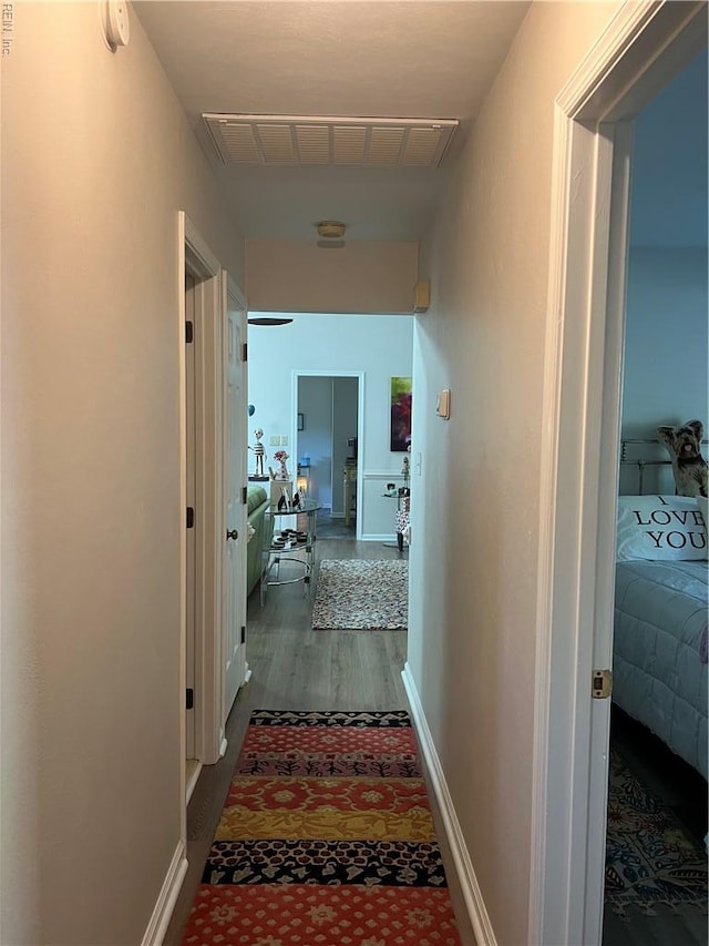 hall featuring visible vents and wood finished floors