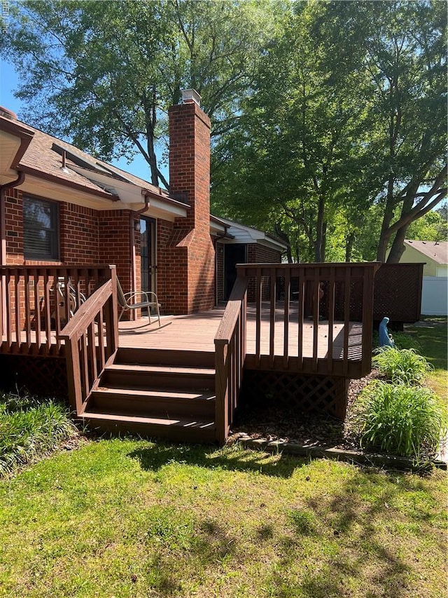 wooden deck with a lawn