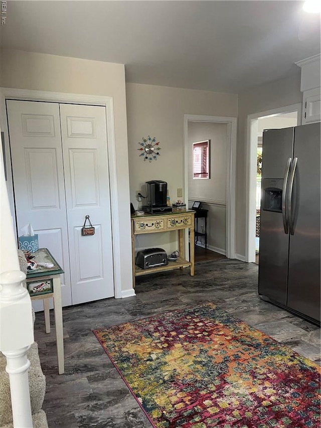 living area featuring dark wood-style flooring and baseboards