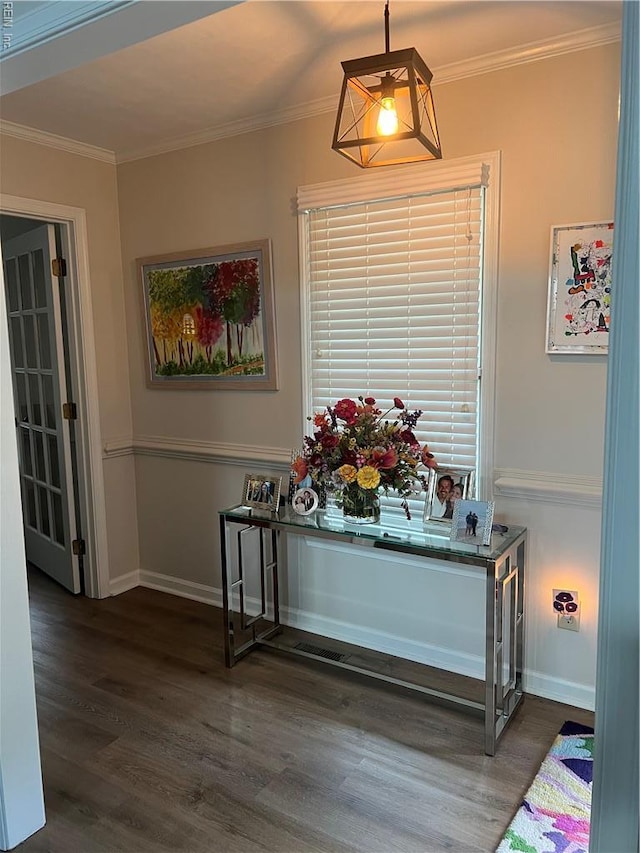 interior details featuring wood finished floors, baseboards, and ornamental molding
