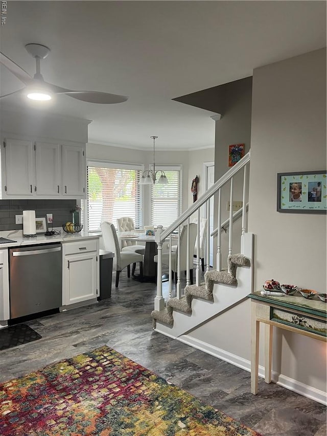 kitchen featuring a ceiling fan, stainless steel dishwasher, white cabinetry, dark wood-type flooring, and light countertops