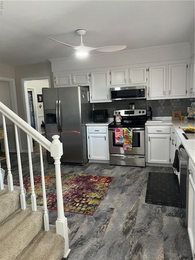 kitchen with ceiling fan, white cabinetry, light countertops, backsplash, and appliances with stainless steel finishes