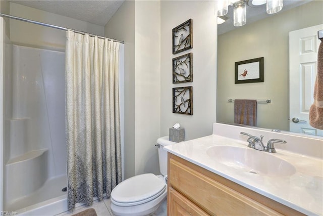 bathroom featuring toilet, a stall shower, vanity, and a textured ceiling