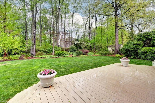 wooden terrace featuring a yard